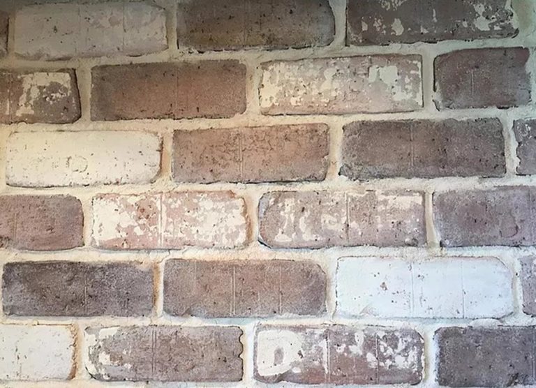 Close-up of weathered brick veneer and mortar joints