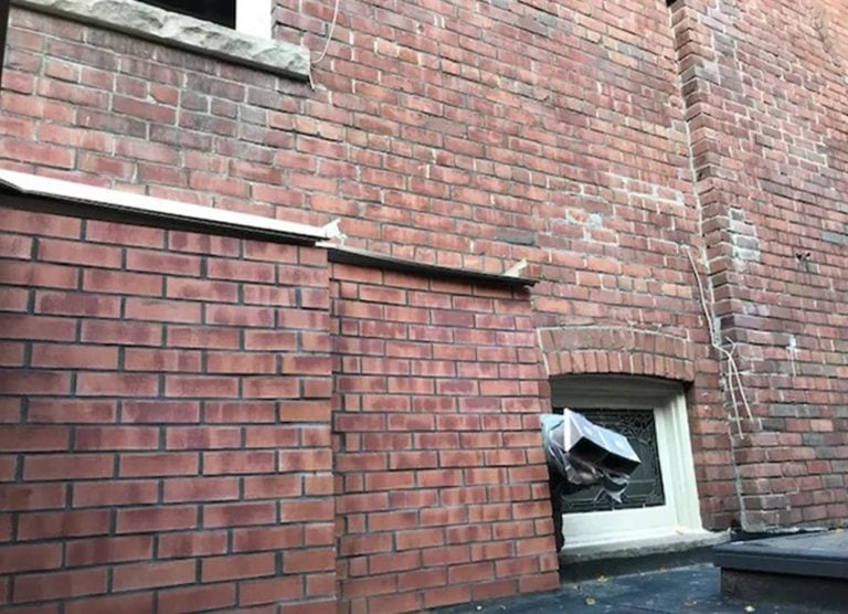 Brick wall with a repaired section matched to the original brick