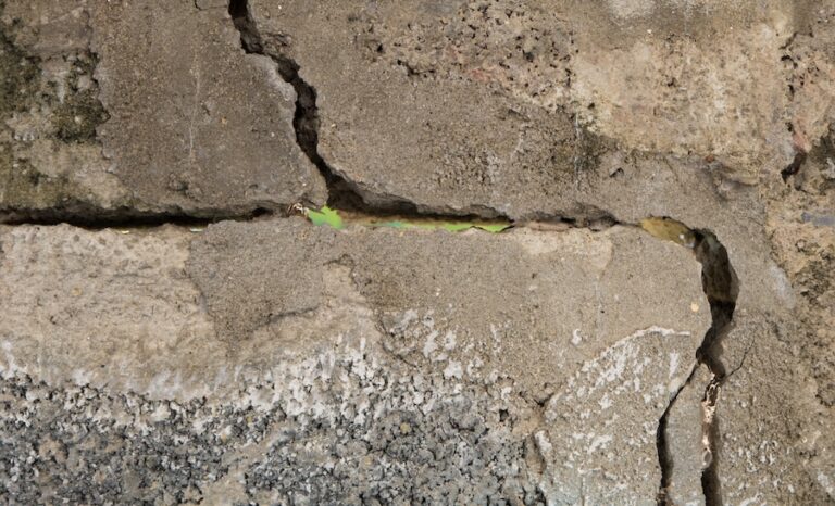 Parging layer protecting the exterior of a foundation wall