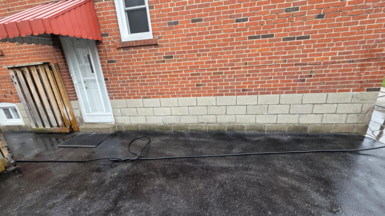 Red brick wall above a concrete block foundation at a Toronto home
